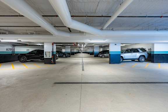 A parking garage with cars parked in it at Damask, Windsor, ON N8S 0B7
