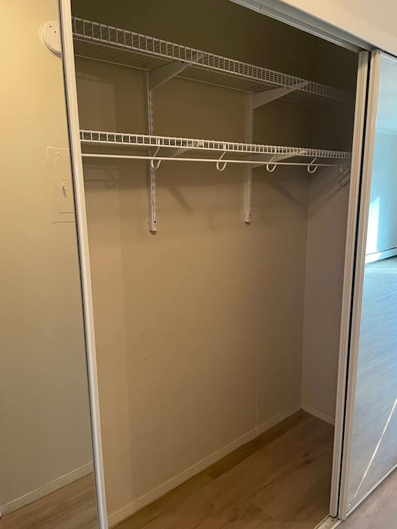 Empty shelves in a white pantry.