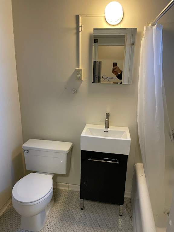 A white toilet and sink in a bathroom.