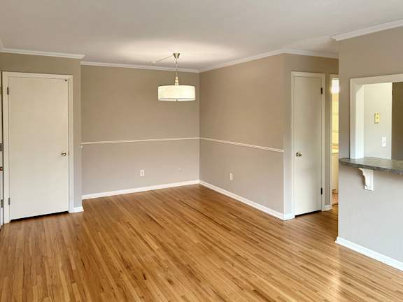A room with wooden floors and white walls.