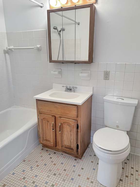 A white toilet sits next to a sink in a bathroom.