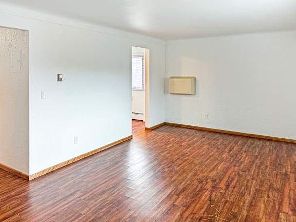 A room with wooden floors and white walls.
