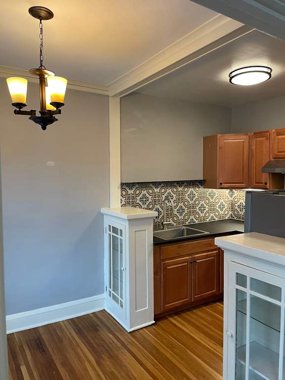 A kitchen with wooden cabinets and a patterned backsplash.