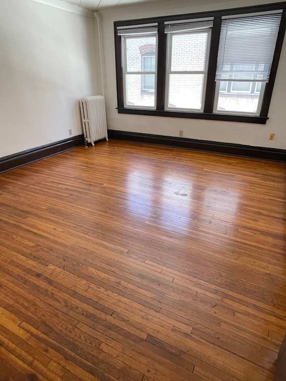 A room with a wooden floor and a window.