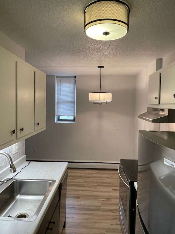 A kitchen with a stainless steel dishwasher and a sink.