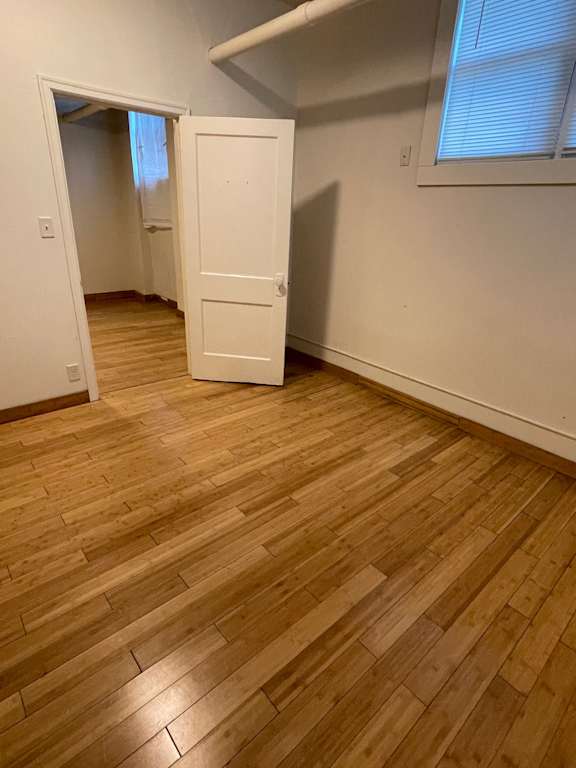 A room with a wooden floor and a white door.