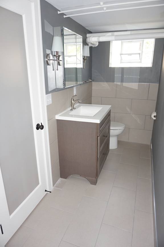 A white sink in a small bathroom.