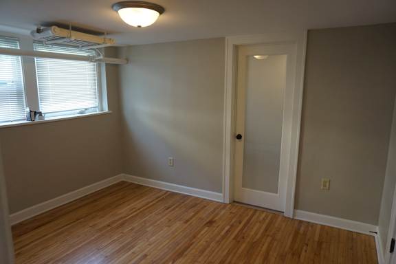 A room with a wooden floor and a door.