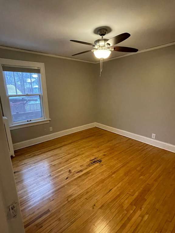 A room with a ceiling fan and a window.