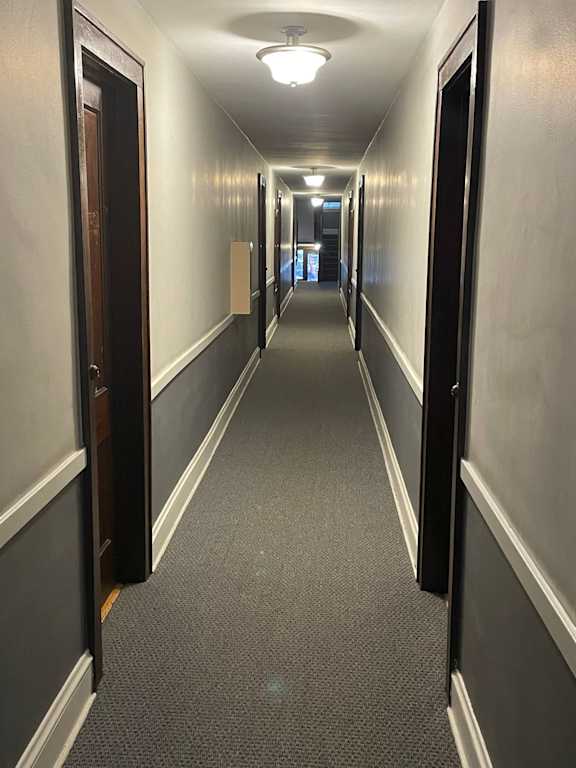 A long hallway with doors on both sides.