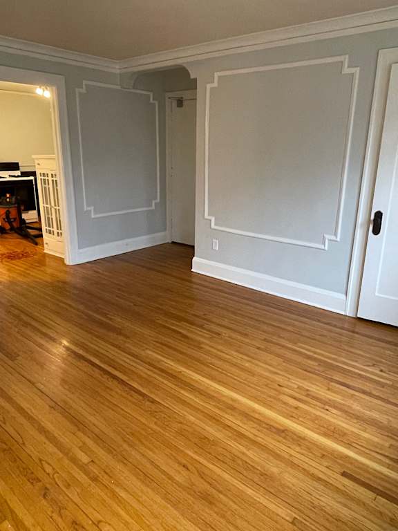A room with wooden floors and white walls.