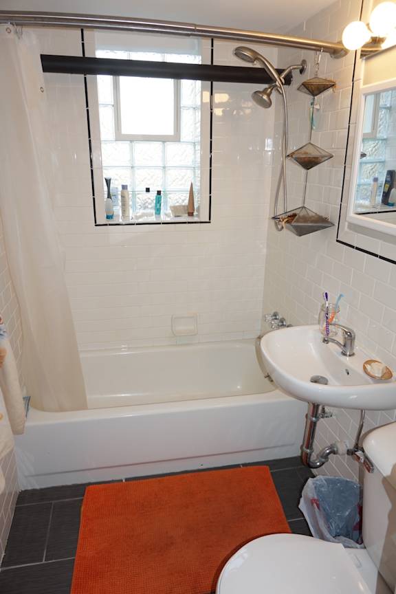 A white sink with a mirror above it in a bathroom.