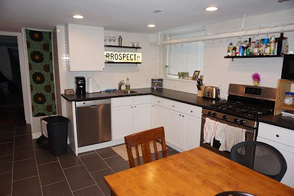A kitchen with a wooden table and a sign that says "PROSPECT".
