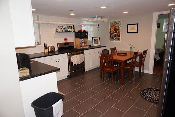 A kitchen with a table and chairs.