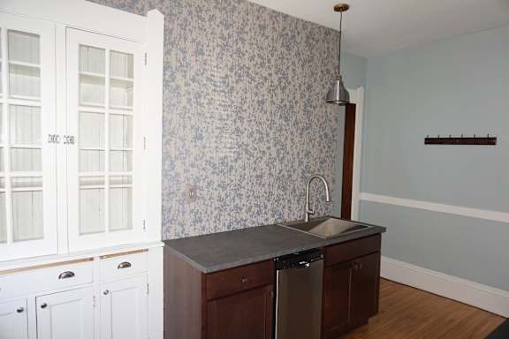 A kitchen with a sink and cabinets.
