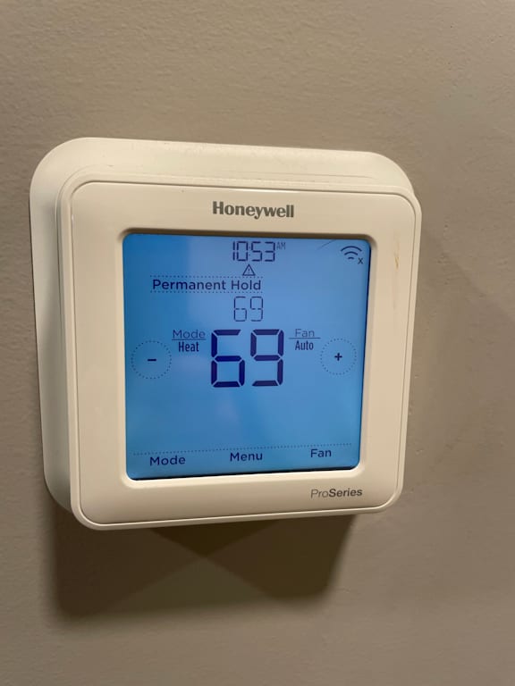 A Honeywell thermostat shows the temperature is 69 degrees.