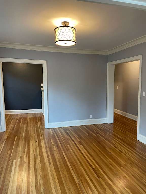 A room with wooden floors and a light fixture.