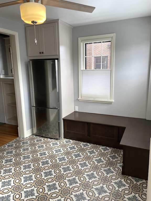 A kitchen with a tile floor and a window.