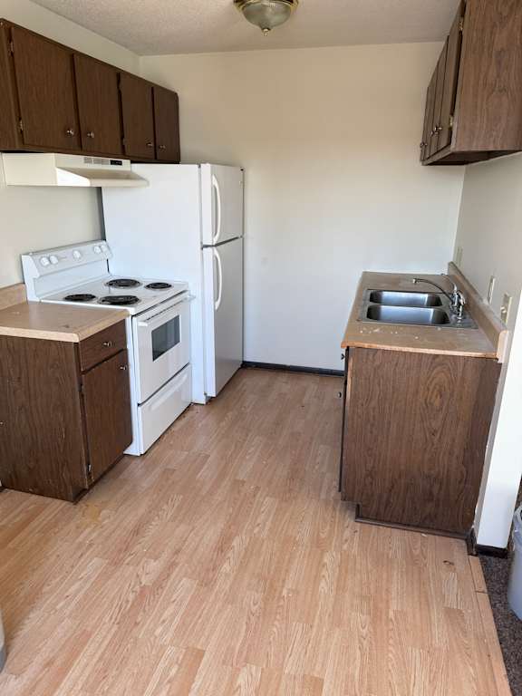 A white stove with a microwave on top of it.
