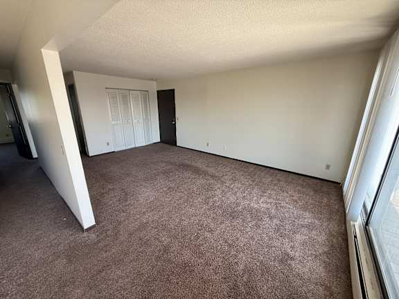 A room with carpeted floor and white walls.