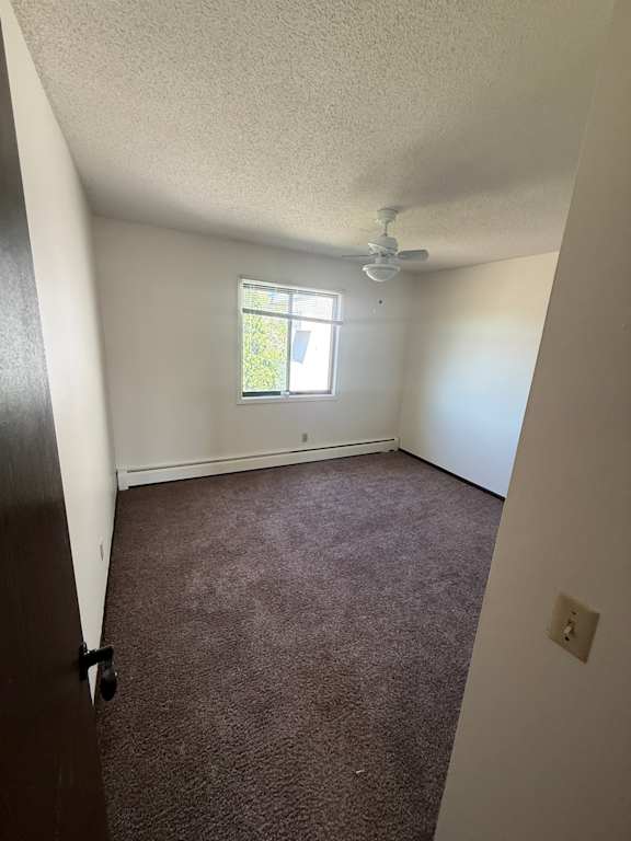 A room with a window and a brown wall.