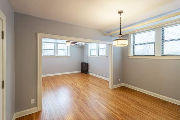 A room with wooden floors and white walls.