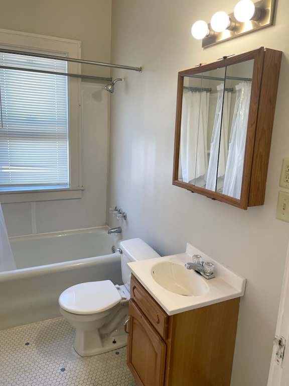A white toilet sits next to a sink in a bathroom.