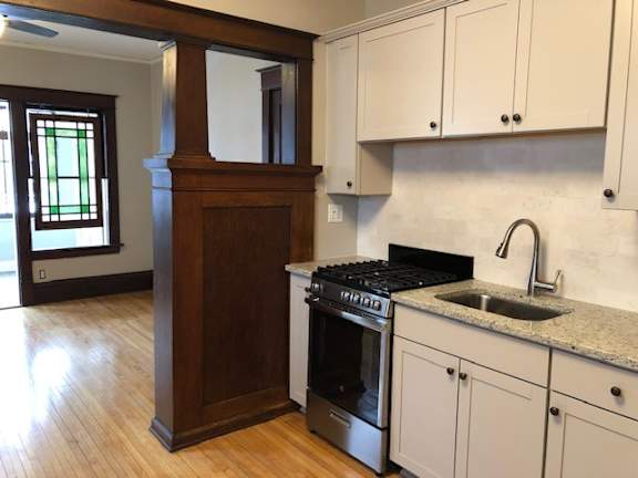 A kitchen with a stove and cabinets.