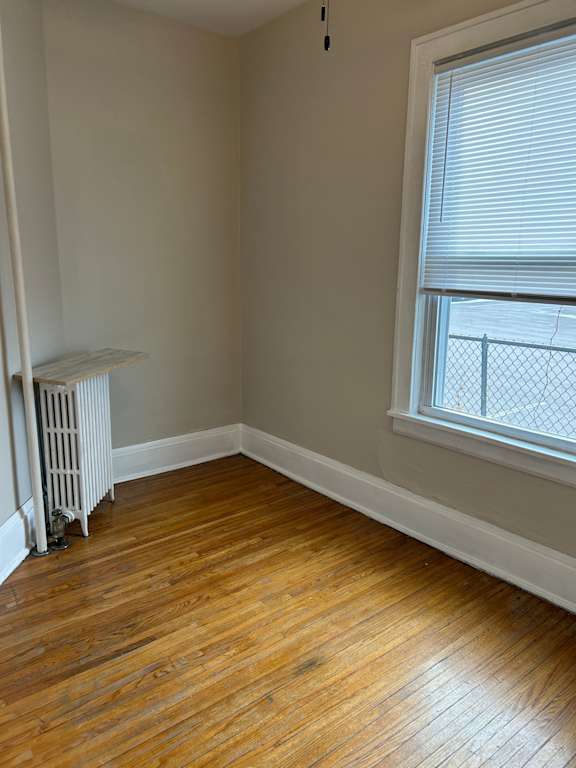 A room with a window and a radiator.