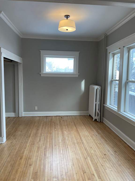 A room with wooden floors and a window.