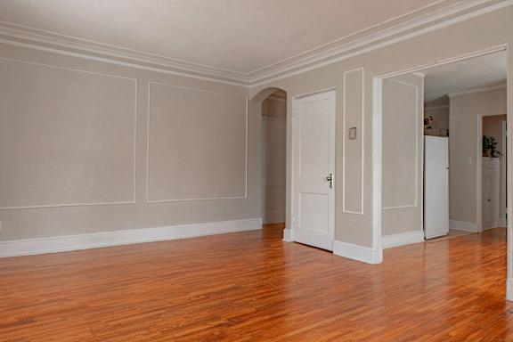 A room with wood floors and white walls.