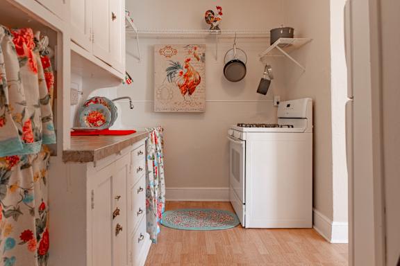 A small kitchen with a washing machine and a fridge.