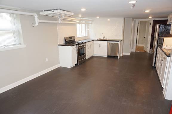 A kitchen with white cabinets and appliances is shown.