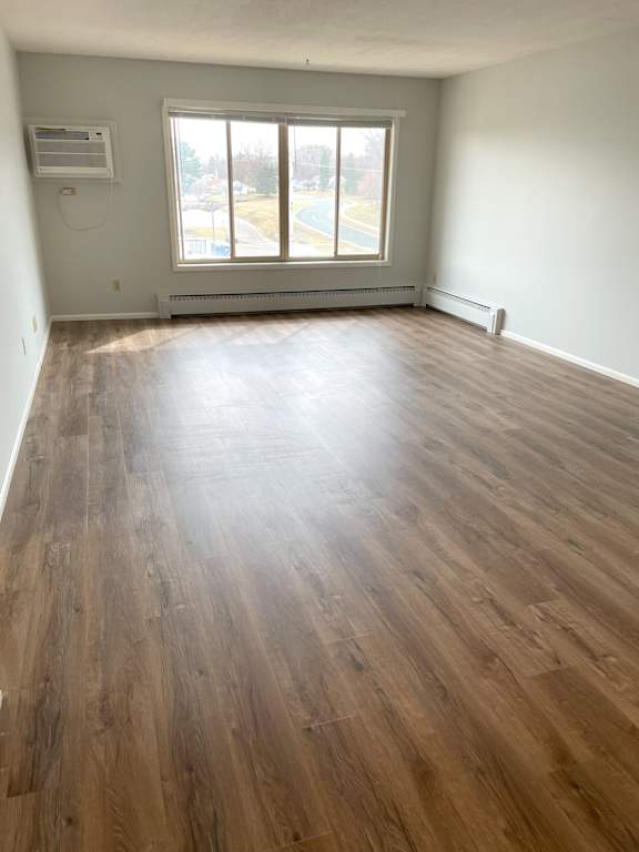 A room with wooden flooring and a window.