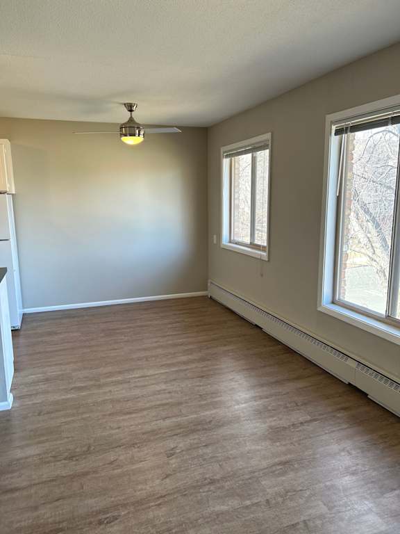A room with a window and a ceiling fan.