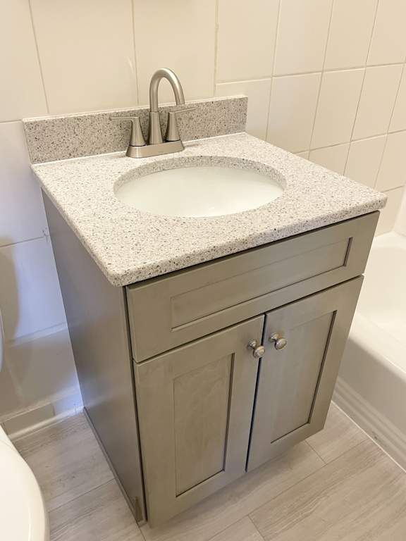 A bathroom sink with a granite countertop and a silver faucet.
