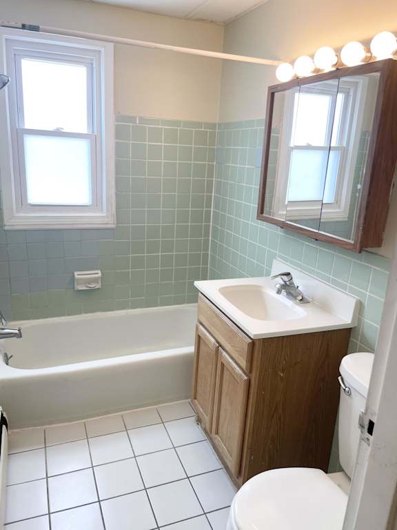 A white toilet sits next to a sink in a bathroom.