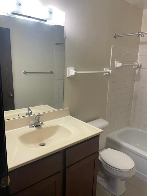 A white toilet sits next to a sink in a bathroom.