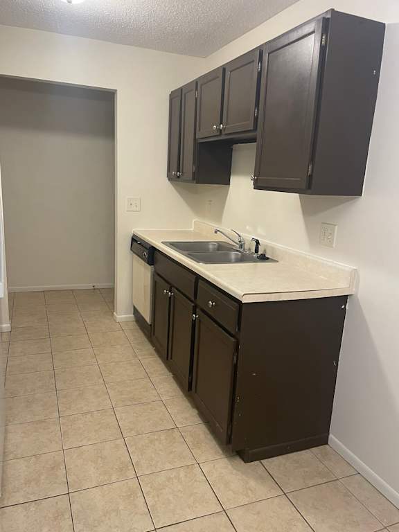 A kitchen with brown cabinets and a white counter.
