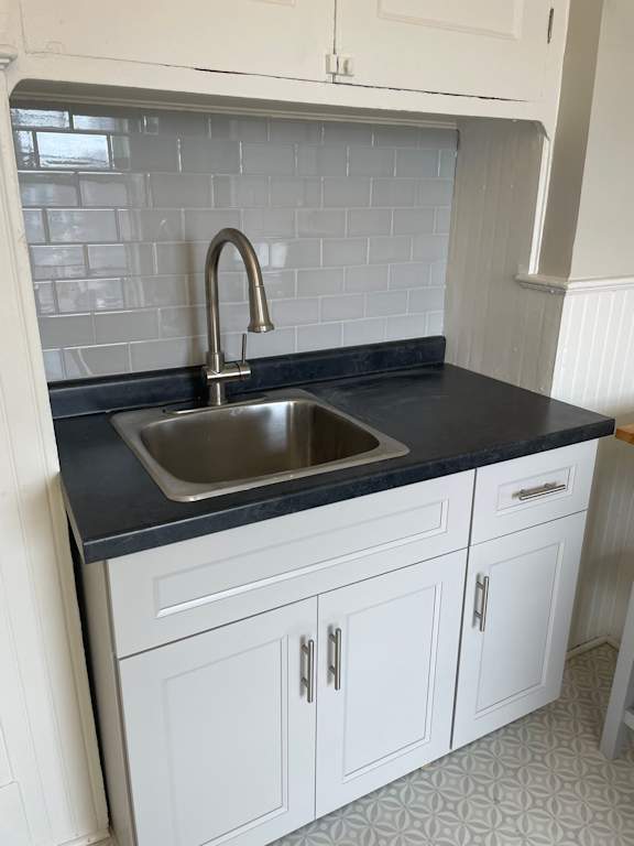 A kitchen with a sink and cabinets.