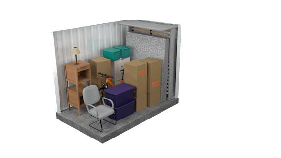 A chair is placed in front of a small table and some boxes in a room.