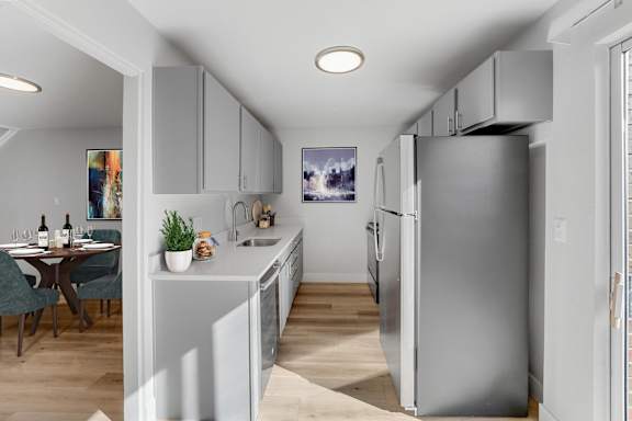 A modern kitchen with a dining table and chairs. at The Lex At Lowry, Colorado, 80224