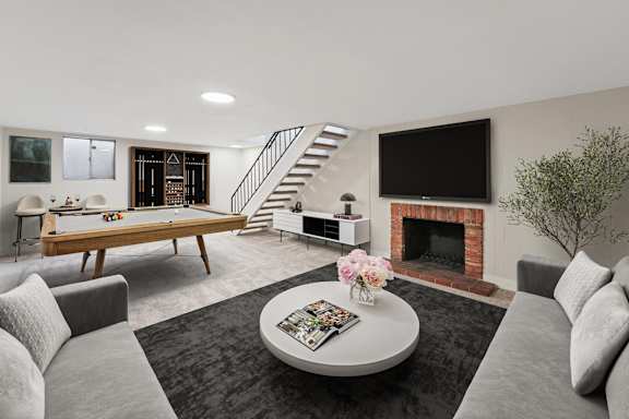 A living room with a grey couch, a coffee table, a fireplace, and a television. at The Lex At Lowry, Denver
