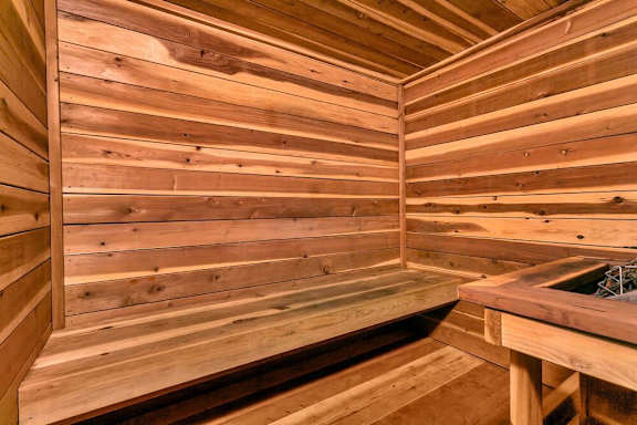 A wooden sauna with a bench and a table. at The Lex At Lowry, Colorado