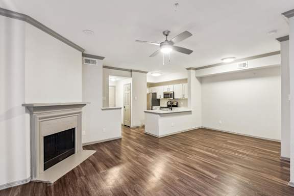 A room with a fireplace and a ceiling fan.at Onyx183, Austin, 78729