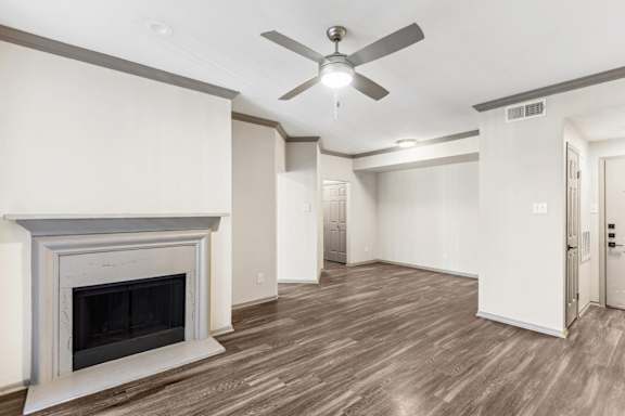 A room with a fireplace and a ceiling fan.at Onyx183, Austin Texas