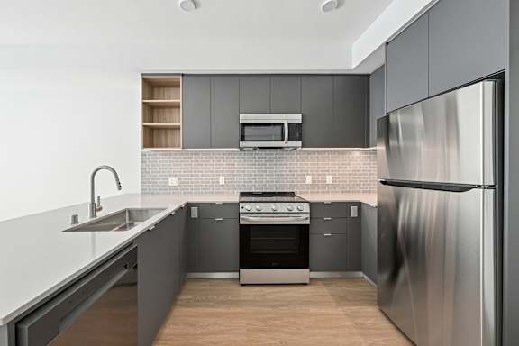 A modern kitchen with a stainless steel refrigerator.