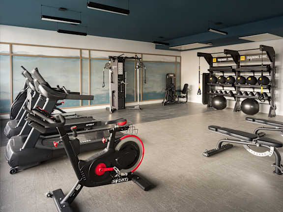 A gym with a stationary bike in the foreground.