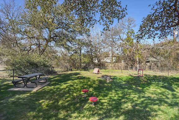 A park with a picnic table and a red object on the grass.at Onyx183, Texas