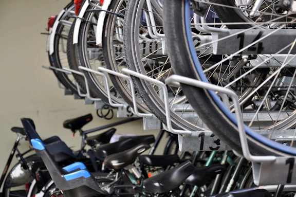 A bunch of bicycles are parked in a bike rack.